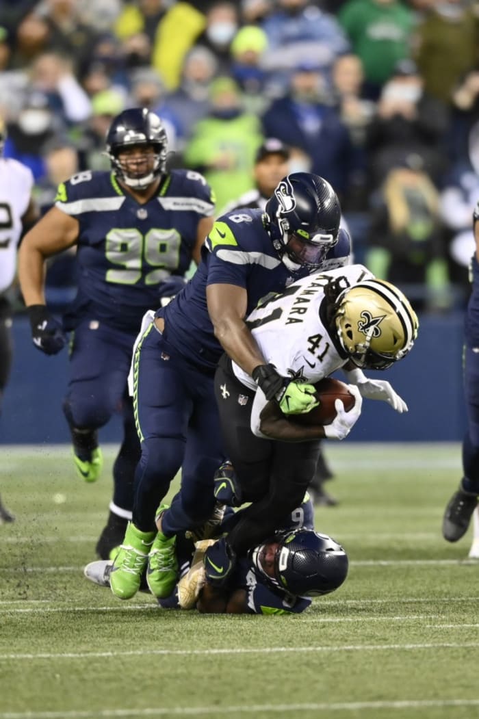 Former Seattle Seahawks defensive end Carlos Dunlap (8) and safety Quandre Diggs (6) tackle New Orleans Saints running back Alvin Kamara (41). Mandatory Credit: Steven Bisig-USA TODAY Sports